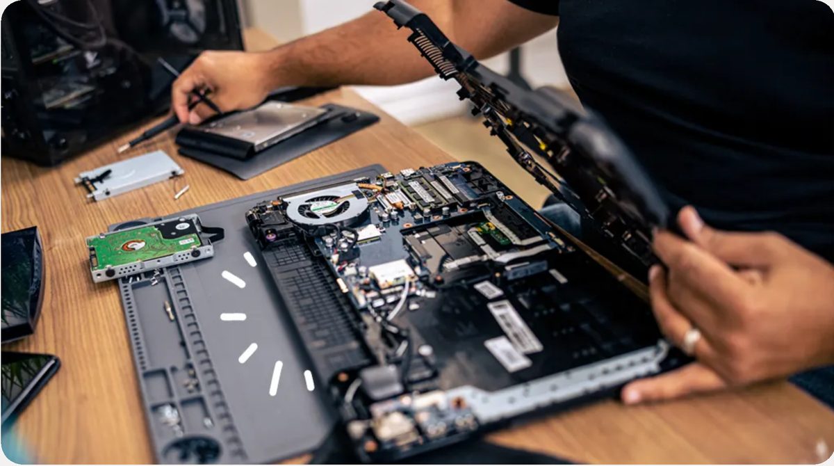 IT support technician repairing laptop hardware